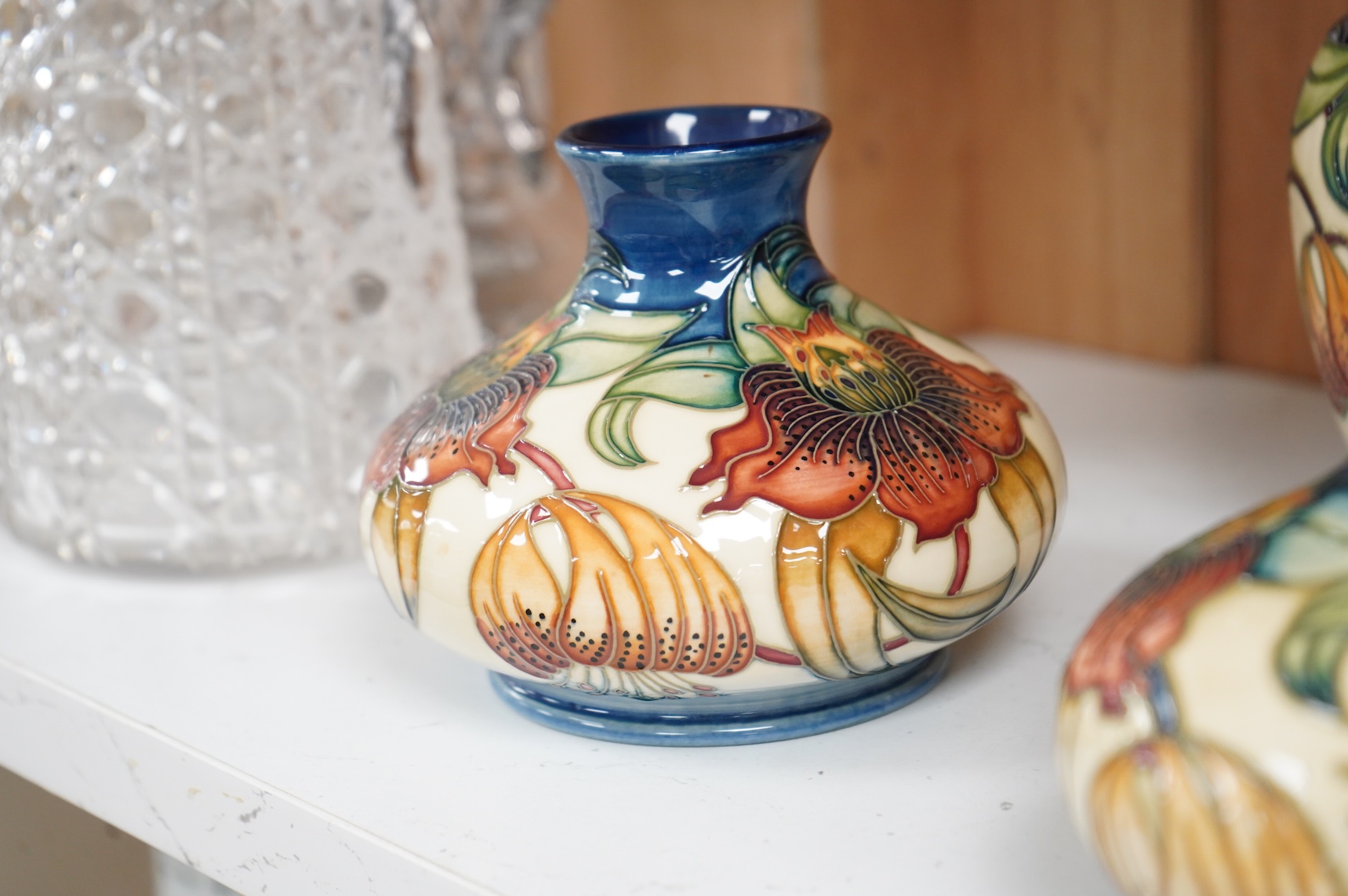Two modern Moorcroft vases and a jar in the Anna Lily pattern, largest 14cm high